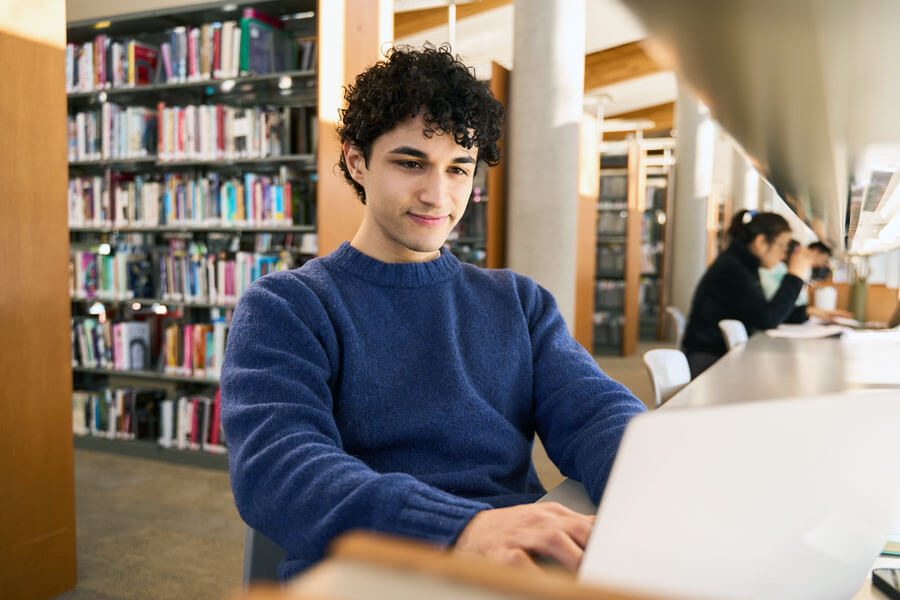 hispanic man studying in library